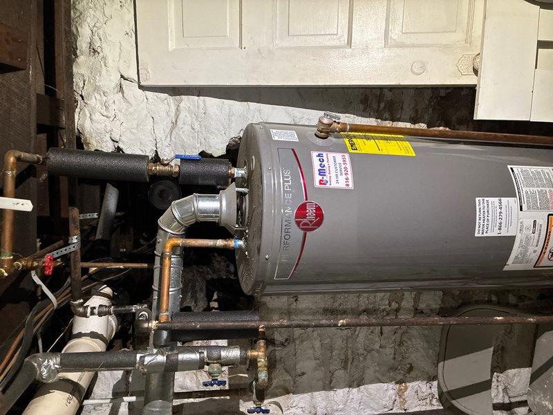 Performed comprehensive whole-home plumbing inspection with no reported issues or concerns. Documented water heater installation in basement utility area, noting Purcell brand unit with proper plumbing connections, shut-off valves, and pressure relief components in place. Inspected attic space and identified PVC plumbing lines with secure mounting; observed significantly deteriorated ductwork insulation wrap showing extensive cracking and degradation requiring attention by HVAC specialist. All accessible plumbing fixtures, supply lines, and drainage systems inspected and photographed for homeowner records.