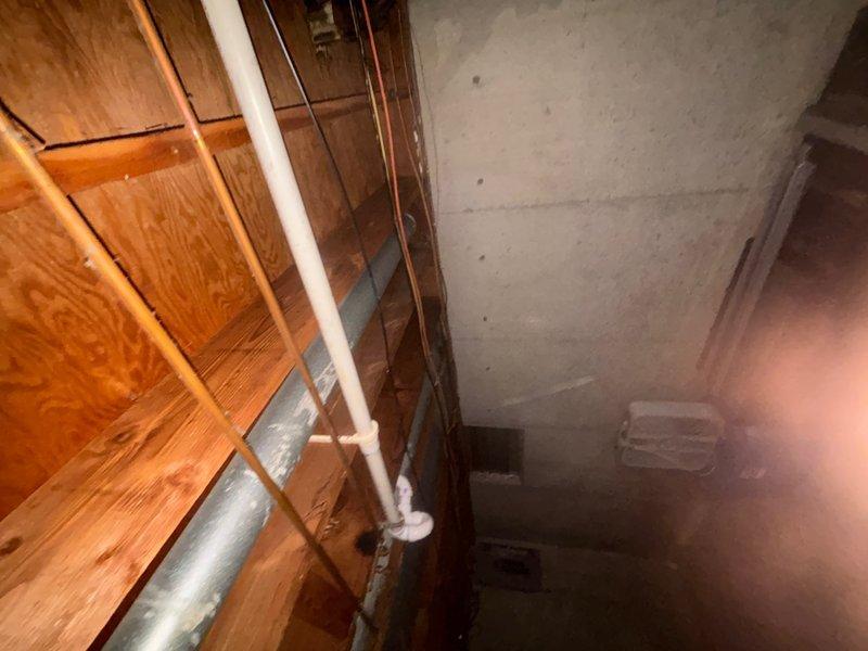 Responded to service call for non-flushing toilets and shower drainage issues. Upon investigation, accessed basement plumbing system and identified main drain line obstruction affecting multiple fixtures. Cleared blockage in primary waste stack and verified proper drainage flow restored to all affected toilets and shower. Inspected PVC drainage piping and connections for proper function and confirmed system operating normally upon completion.