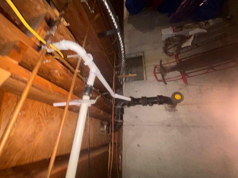 Responded to service call for non-flushing toilets and shower drainage issues. Upon investigation, accessed basement plumbing system and identified main drain line obstruction affecting multiple fixtures. Cleared blockage in primary waste stack and verified proper drainage flow restored to all affected toilets and shower. Inspected PVC drainage piping and connections for proper function and confirmed system operating normally upon completion.