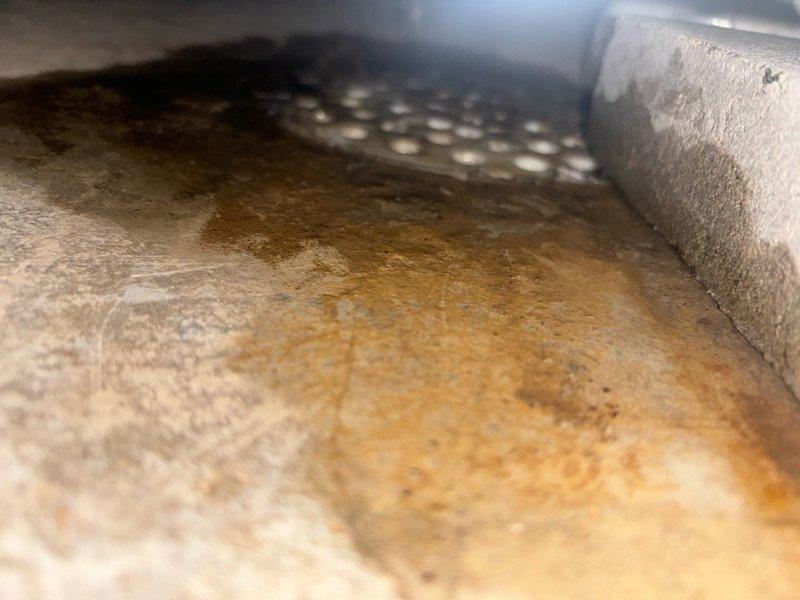 Responded to emergency service call for clogged condensate drain line located beneath HVAC furnace unit in basement. Upon inspection, found significant accumulation of dust, debris, and sediment within drain pan and surrounding ductwork area, causing drainage blockage. Cleared obstruction from condensate drain line, removed accumulated debris from drain pan, and verified proper water flow through drainage system to restore normal operation.
