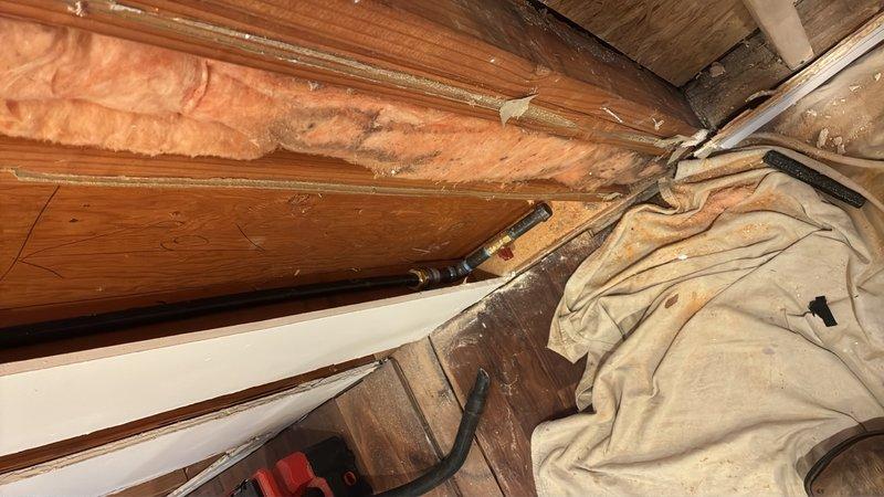Installed new gas line from main line in attic to kitchen stove location for kitchen remodel. Ran flash shield piping with shut-off valves at main line connection and behind stove, installed stud guards in walls to protect gas line during routing, and capped line at stove location. Performed pressure testing to verify system integrity and confirm no leaks present upon completion.