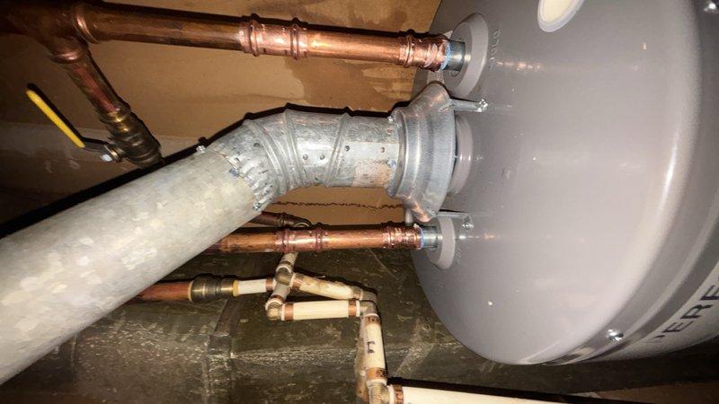 Removed existing tank-style water heater and installed customer-supplied replacement unit in basement utility area. Completed all plumbing connections using copper piping with compression fittings for hot and cold water supply lines, installed proper venting with metallic flexible duct secured with metal clamps, and connected gas line with shutoff valve. Verified all connections meet current code requirements and tested system for proper operation and safety compliance.