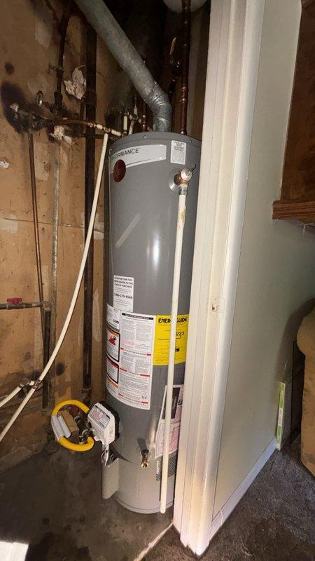 Removed existing tank-style water heater and installed customer-supplied replacement unit in basement utility area. Completed all plumbing connections using copper piping with compression fittings for hot and cold water supply lines, installed proper venting with metallic flexible duct secured with metal clamps, and connected gas line with shutoff valve. Verified all connections meet current code requirements and tested system for proper operation and safety compliance.