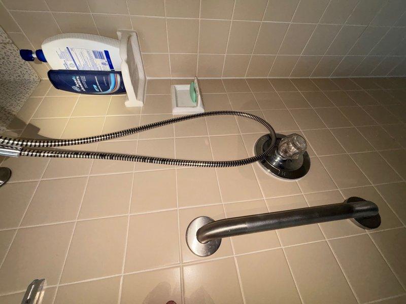 Responded to report of dripping faucet in first-floor bathroom shower. Inspected shower valve assembly and identified worn cartridge causing leak. Disassembled single-handle shower control, replaced defective cartridge, and reassembled fixture. Tested operation to verify proper hot/cold water mixing and confirmed leak was eliminated.