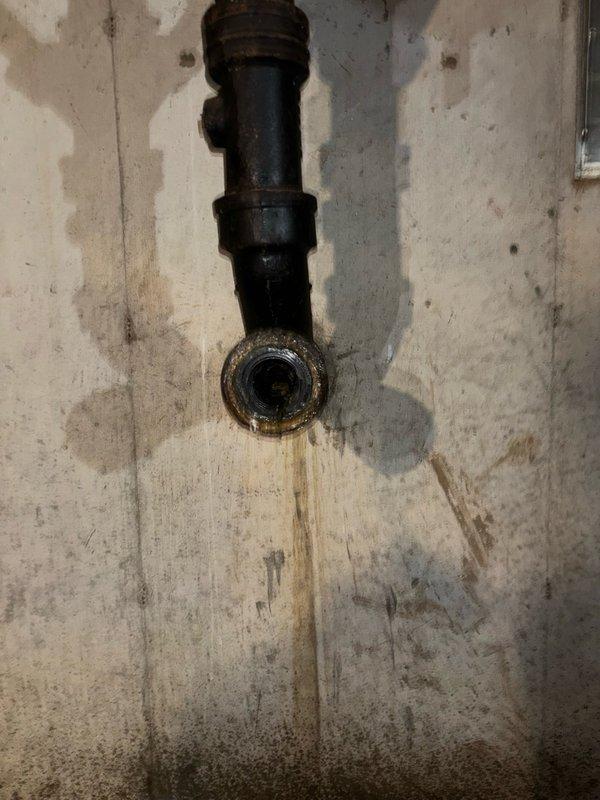 Performed hydro-jetting service on clogged drain line to restore proper flow and drainage. Conducted camera inspection of main line to assess pipe condition, revealing corrosion at pipe connection point and evidence of moisture intrusion along the drainage system. Documentation captured showing deteriorated pipe fixture with significant rust buildup and water damage to surrounding wall surfaces, indicating long-term drainage issues that were addressed through the jetting procedure.