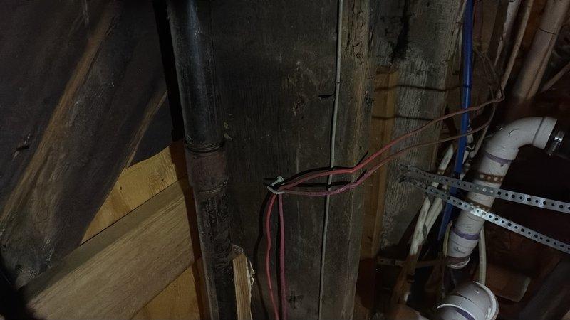 Conducted site assessment for gas line installation to rooftop HVAC unit. Evaluated existing utility infrastructure in basement area, documenting current plumbing and electrical routing to determine optimal path for new gas line. Photographed exterior penetration points and identified routing requirements from ground level to roof-mounted equipment to facilitate installation planning.