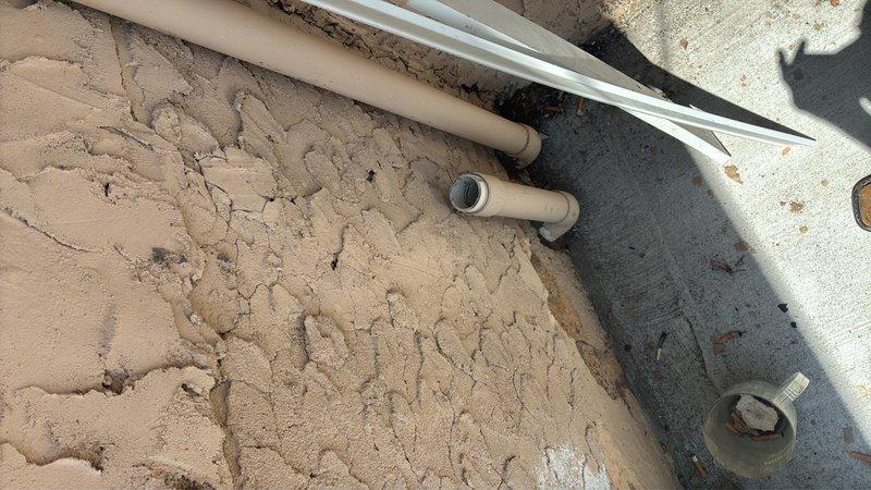 Conducted site assessment for gas line installation to rooftop HVAC unit. Evaluated existing utility infrastructure in basement area, documenting current plumbing and electrical routing to determine optimal path for new gas line. Photographed exterior penetration points and identified routing requirements from ground level to roof-mounted equipment to facilitate installation planning.