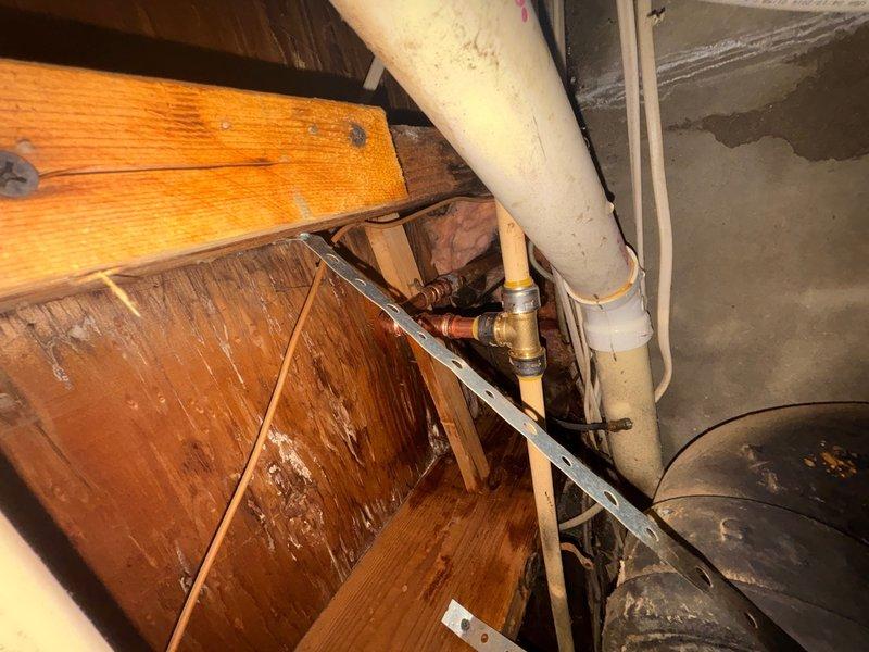 Responded to emergency plumbing call for broken faucet in basement causing active water leak. Upon arrival, located failed faucet fixture in basement utility area near HVAC equipment and successfully stopped water flow to prevent further damage. Assessed plumbing infrastructure including exposed copper supply lines and PVC drainage system, verified all connections were secure, and confirmed leak was isolated to the faucet assembly requiring replacement or repair.