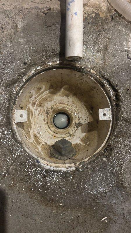Responded to a backed-up floor drain in basement utility area. Upon arrival, found standing water pooled across concrete floor with significant accumulation around the drain assembly. Cleared blockage from the floor drain using mechanical augering methods, removed accumulated debris and sediment from drain basin, and verified proper water flow and drainage. Tested system to confirm complete restoration of drainage function.