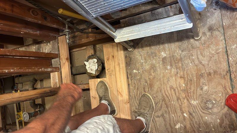 Completed plumbing estimate for pipe revision work requiring vertical adjustment of existing piping system. Assessed attic/crawlspace area to determine scope of work needed to lower pipes as specified, documenting current framing configuration and clearance constraints that will impact pipe routing modifications.