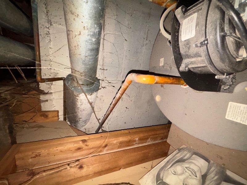 Responded to callback for no hot water following previous repair. Upon arrival, inspected water heater unit and associated plumbing connections. Found water heater functioning properly with control module showing normal operation indicators. Examined copper supply lines and corrugated flex connector for any issues that may have developed post-repair. Verified temperature settings on control dial and confirmed pilot light and burner operation. Tested hot water flow at fixtures and confirmed system restored to full operational status. Documented equipment condition with photographs showing water heater installation, piping connections, and HVAC ductwork in mechanical space.