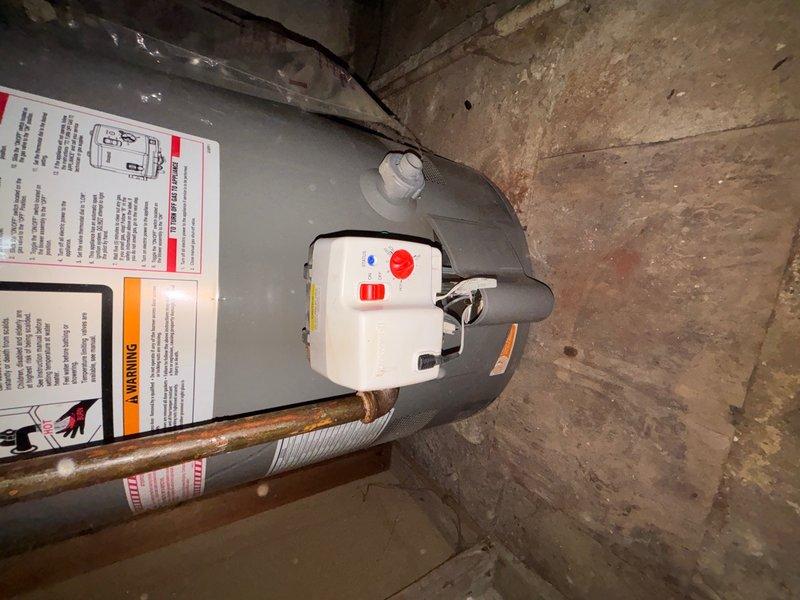 Responded to callback for no hot water following previous repair. Upon arrival, inspected water heater unit and associated plumbing connections. Found water heater functioning properly with control module showing normal operation indicators. Examined copper supply lines and corrugated flex connector for any issues that may have developed post-repair. Verified temperature settings on control dial and confirmed pilot light and burner operation. Tested hot water flow at fixtures and confirmed system restored to full operational status. Documented equipment condition with photographs showing water heater installation, piping connections, and HVAC ductwork in mechanical space.