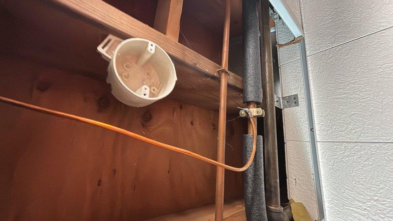 Responded to a multi-point plumbing service call at a 1978-built residence. Investigated and addressed low water pressure issue at the main bathroom sink by inspecting supply lines and fixtures. Evaluated the kitchen area to relocate refrigerator water supply connection from hot water line to cold water line to ensure proper appliance operation. Assessed basement utility area for installation of new utility sink, reviewing existing plumbing infrastructure including water heater, supply lines, and drainage access points. Documented existing conditions of unfinished basement space with exposed framing and concrete foundation walls to determine optimal routing for new sink installation. All requested services evaluated and primary water pressure concern at bathroom sink resolved.