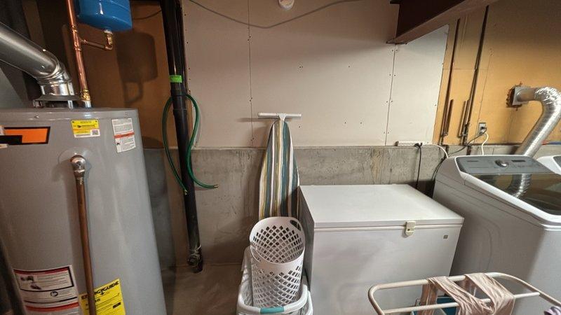 Responded to a multi-point plumbing service call at a 1978-built residence. Investigated and addressed low water pressure issue at the main bathroom sink by inspecting supply lines and fixtures. Evaluated the kitchen area to relocate refrigerator water supply connection from hot water line to cold water line to ensure proper appliance operation. Assessed basement utility area for installation of new utility sink, reviewing existing plumbing infrastructure including water heater, supply lines, and drainage access points. Documented existing conditions of unfinished basement space with exposed framing and concrete foundation walls to determine optimal routing for new sink installation. All requested services evaluated and primary water pressure concern at bathroom sink resolved.