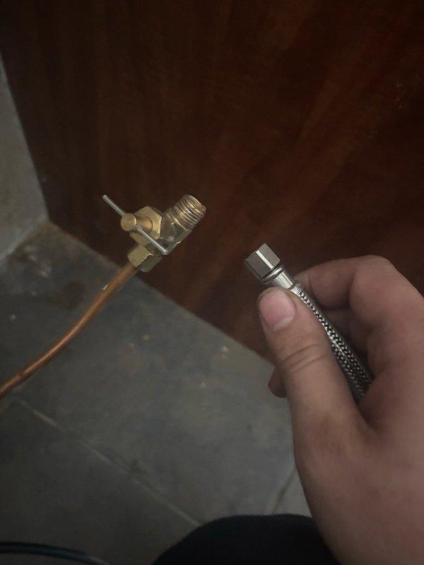 Responded to low water pressure issue at refrigerator caused by incorrect water supply line installation. Removed improperly sized hose from water line connection and installed correct fitting and supply line to refrigerator. Verified proper water flow and confirmed operational status of both water dispenser and ice maker functions.