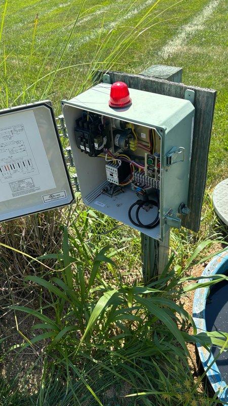 Responded to grinder pump alarm that was triggered due to seal failure. Upon arrival, inspected the outdoor grinder pit control panel and access point where sewage was present around the pit area. Opened and examined the electrical control panel components, including circuit breakers, wiring, and control relays to verify alarm functionality. Accessed the grinder pit chamber to assess the seal condition and sewage accumulation. Documented the failed seal and sewage leakage with photographs of both the control panel system and the open pit access point for service records.