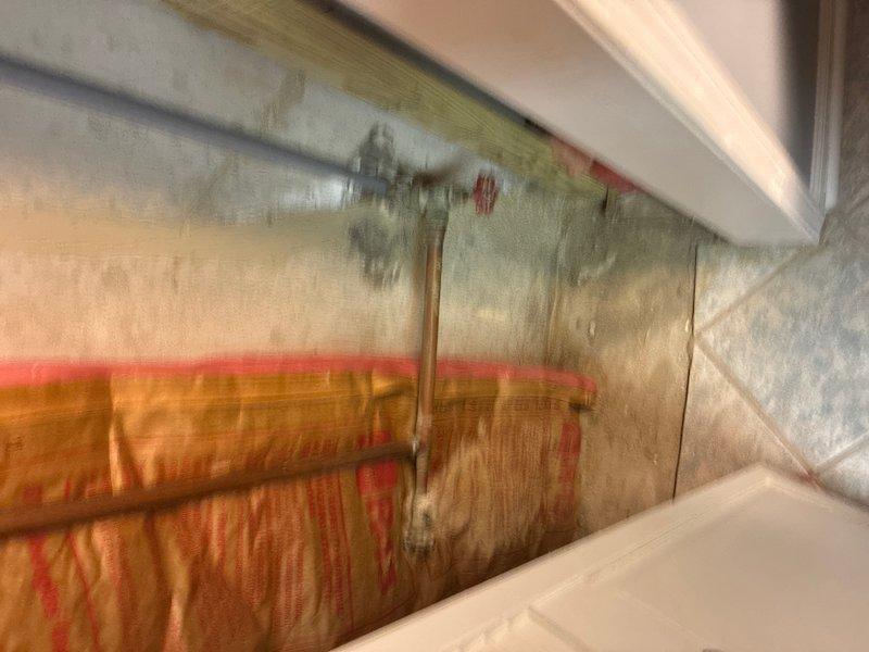 Conducted free estimate for replacement of 15+ year old 50-gallon gas water heater located in basement. Evaluated existing Bradford White Defender Safety System unit, which is currently operational but has exceeded recommended service life. Assessed installation configuration including copper supply lines with shut-off valves, galvanized vent piping, and connections to existing gas line. Photographed current water heater setup and surrounding mechanical room layout to prepare accurate replacement quote for 50-gallon gas unit with comparable specifications.