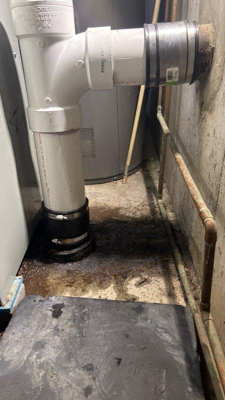 Removed and replaced a leaking 90-degree elbow fitting located behind the furnace and water heater. Installed a new PVC tee fitting with cleanout access point to provide additional entry for future sewer line maintenance and cleaning. The replacement piping now provides improved access and functionality for the drainage system while eliminating the active leak.
