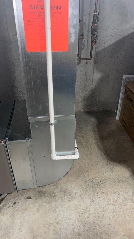 Replaced existing sump pump with new 1/3 HP unit installed in sump basin with grated cover. Routed two separate PVC drain lines across basement floor to sump pit to accommodate humidifier and air conditioning condensate drainage, ensuring proper gravity flow and connection to pump discharge system.