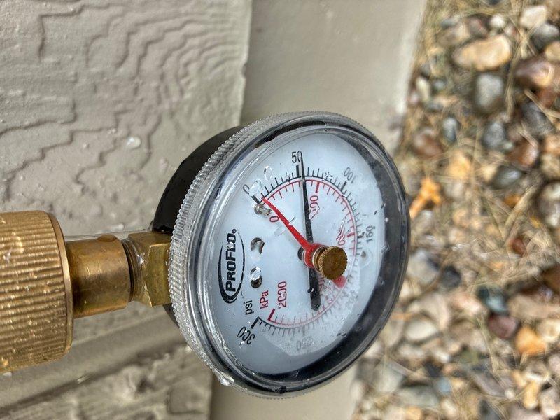 Responded to low water pressure complaint affecting household fixtures, including toilet flushing issues. Upon arrival, conducted diagnostic pressure testing using calibrated gauge at exterior hose bib connection point. Pressure reading indicated significantly reduced system pressure near zero PSI, confirming inadequate water supply to the residence. Inspected main water supply line and shutoff valve for potential restrictions or partial closure. Located corroded shutoff valve with deteriorated internal components causing flow restriction. Performed valve repair to restore proper water pressure throughout the plumbing system. Verified adequate pressure restoration and confirmed toilet flush mechanism operating normally. Documented conditions with diagnostic pressure gauge readings and existing plumbing infrastructure.