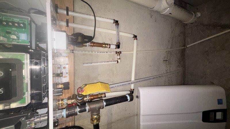 Responded to service call for reported lack of hot water from tankless water heater system in basement. Upon arrival, performed diagnostic inspection of the tankless unit and associated plumbing infrastructure. Examined the water heater controls, verified power supply to the unit, and assessed water flow through the system. Inspected all visible piping connections, including PEX supply lines and brass fittings mounted to the utility board. Checked the electronic control panel for error codes and proper operation. Verified the unit's operational status and confirmed restoration of hot water delivery to the residence.