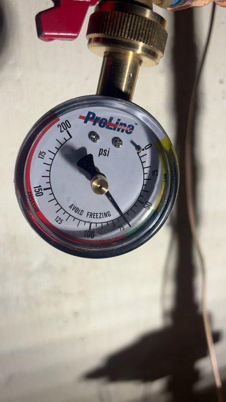Responded to callback regarding pipe vibration and singing noise following recent pressure reducing valve installation. Upon inspection, confirmed water pressure was within acceptable range as indicated by system gauge. Identified water hammer condition caused by PRV setting creating excessive flow velocity through copper piping. Adjusted PRV to optimize pressure balance, reducing vibration while maintaining adequate system pressure. Verified all soldered joints and connections at water heater assembly for security. Tested system operation and confirmed elimination of singing noise in pipes throughout pressure cycles.
