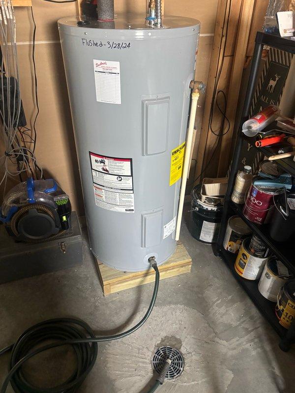Performed comprehensive maintenance on residential tanked water heater, including complete system flush to remove sediment buildup and replacement of the original equipment manufacturer (OEM) anode rod as recommended by manufacturer specifications. Documentation was marked on the unit indicating service completion, ensuring proper maintenance records for future reference.