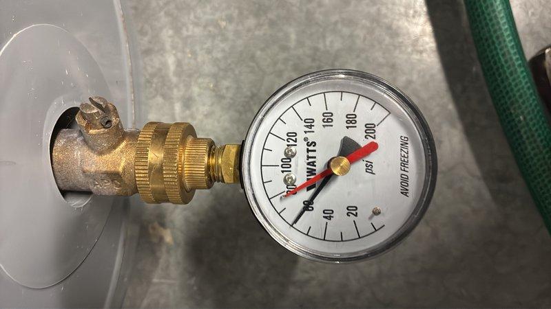 Conducted on-site assessment of 8-year-old electric water heater located in basement to provide replacement estimate for 50-gallon capacity unit. Inspected existing equipment, documented current installation configuration, and tested system pressure using calibration gauge to ensure accurate specifications for replacement proposal.