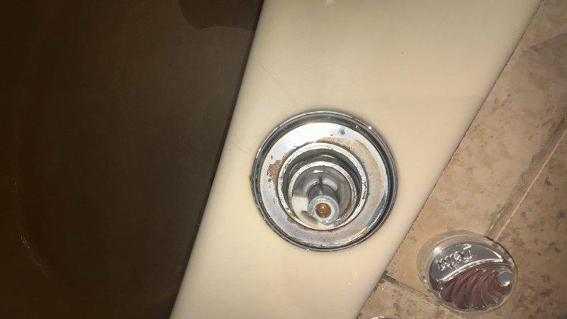 Responded to reported leaking faucets and low water pressure issues in bathroom fixtures. Upon inspection, identified worn internal components and mineral buildup affecting performance. Replaced deteriorated Peerless brand faucet cartridge and addressed corroded drain assembly showing rust discoloration. Cleared aerators and supply lines to restore proper water pressure. Tested all fixtures post-repair to confirm elimination of leaks and verification of adequate flow rate.