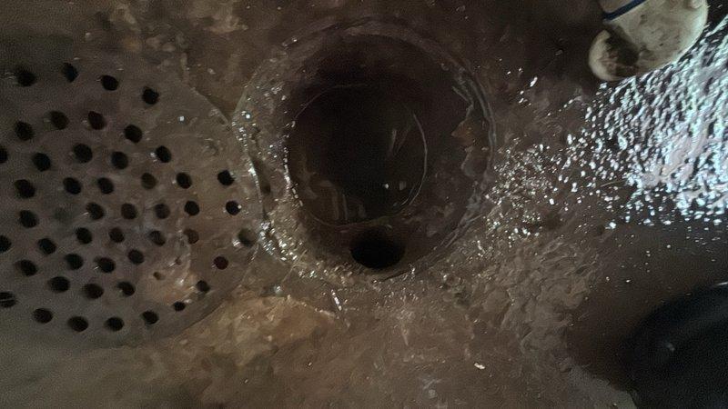 Responded to a clogged floor drain in the garage. Upon arrival, found standing water on the concrete floor surrounding the drain area, indicating a complete blockage in the drainage system. Successfully cleared the obstruction from the floor drain, restoring proper water flow and drainage function.