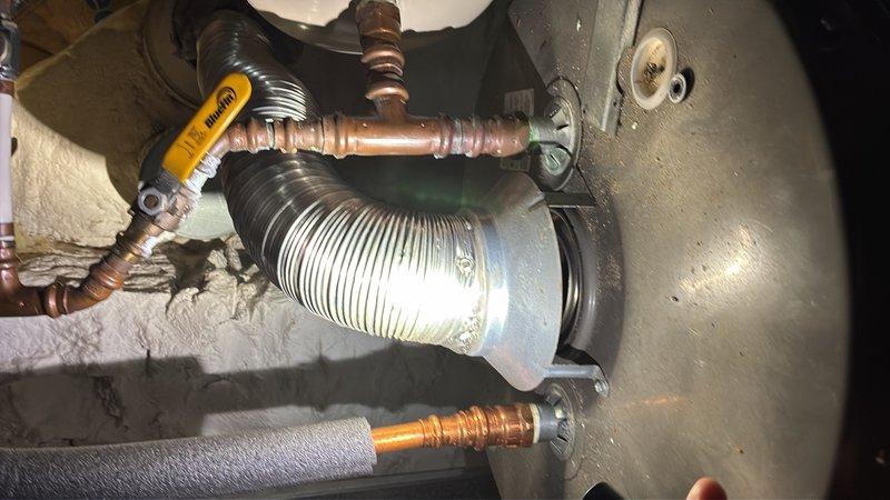 Responded to concern regarding potential gas leak and moisture buildup related to gas water heater flue and chimney system in basement. Performed thorough inspection of water heater venting components, flue pipe connections, and draft hood assembly. Examined chimney chase and flue termination for proper draft and condensation issues. Verified all gas connections, tested for leaks, and confirmed proper combustion air supply and ventilation. Documented existing conditions of copper supply lines, pressure relief valve, and venting system components showing normal wear patterns.