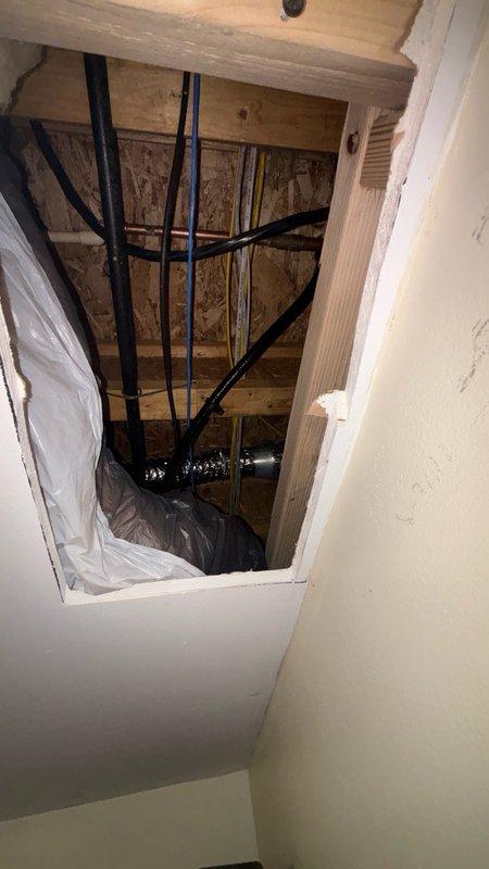 Installed new gas line from main 1" gas supply to kitchen stove location. Created ceiling access point through finished closet below kitchen to route piping. Ran black iron pipe through unfinished mechanical area where water heater and furnace are located, tied into existing 1" gas main with dedicated shut-off valve. Installed shut-off valve behind stove for appliance isolation and code compliance.