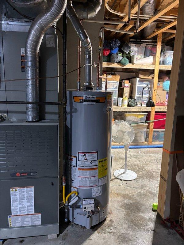 Installed a new 50-gallon gas water heater in basement utility area with thermal expansion tank to protect against pressure buildup in the closed plumbing system. Retrieved and installed extended warranty kit from supply house, upgrading the manufacturer's tank warranty from 6 years to 10 years. Connected all copper supply lines, yellow flexible gas line, and properly secured the thermal expansion tank to the wall with metal strapping, ensuring all components meet code requirements and safety standards.