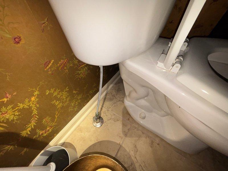 Completed comprehensive plumbing inspection of residential bathroom facility. Examined toilet assembly with bidet attachment, pedestal sink, and associated water supply lines and drain connections. All fixtures photographed and documented, including under-sink plumbing components showing standard drain pipe assembly with minor surface wear and mineral deposits present on basin drain area.