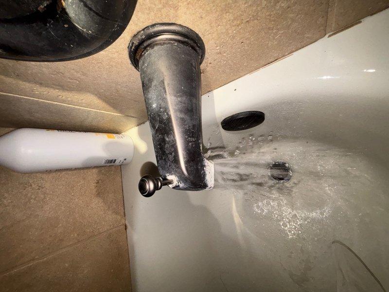 Completed comprehensive plumbing inspection of residential bathroom facility. Examined toilet assembly with bidet attachment, pedestal sink, and associated water supply lines and drain connections. All fixtures photographed and documented, including under-sink plumbing components showing standard drain pipe assembly with minor surface wear and mineral deposits present on basin drain area.