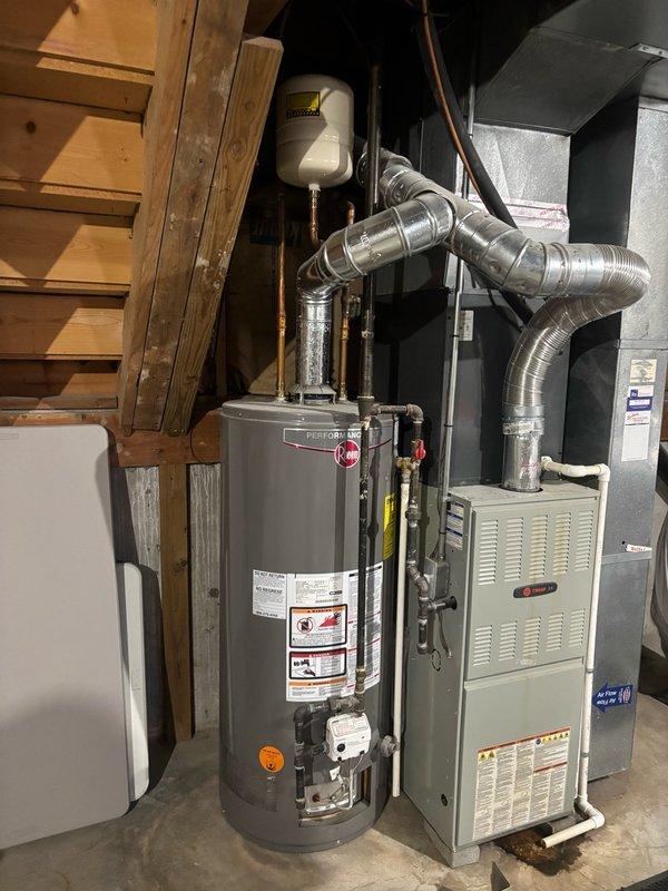 Responded to no hot water complaint in basement mechanical room. Upon arrival, inspected tankless water heater unit and associated gas burner assembly. Verified gas burner was igniting properly with characteristic blue flame base and proper combustion pattern across multiple flame ports. Checked all copper supply lines, shut-off valves, and connections to water heater for proper operation. Confirmed expansion tank mounting and plumbing system integration. System tested and restored to full operational status with adequate hot water delivery.