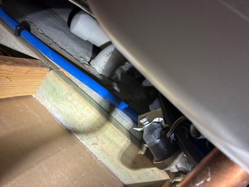 Completed comprehensive whole home plumbing inspection examining all accessible fixtures and components. Inspected toilet tank mechanism including flush valve assembly, flapper condition, and chain connection, confirming proper operation. Evaluated under-sink plumbing infrastructure including P-trap configuration, PVC drainage connections, supply line valves, and structural support mounting, verifying all components are functioning without visible leaks or deficiencies.