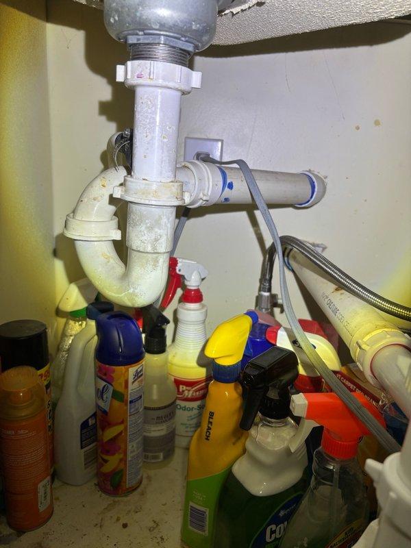 Completed comprehensive whole home plumbing inspection. Examined under-sink plumbing configuration including P-trap assembly and supply lines, which appeared functional with age-appropriate discoloration. Identified significant condensation issue on main copper supply line in mechanical space, indicating possible insulation deficiency or temperature differential concerns that may require attention to prevent ongoing moisture problems and potential pipe damage.