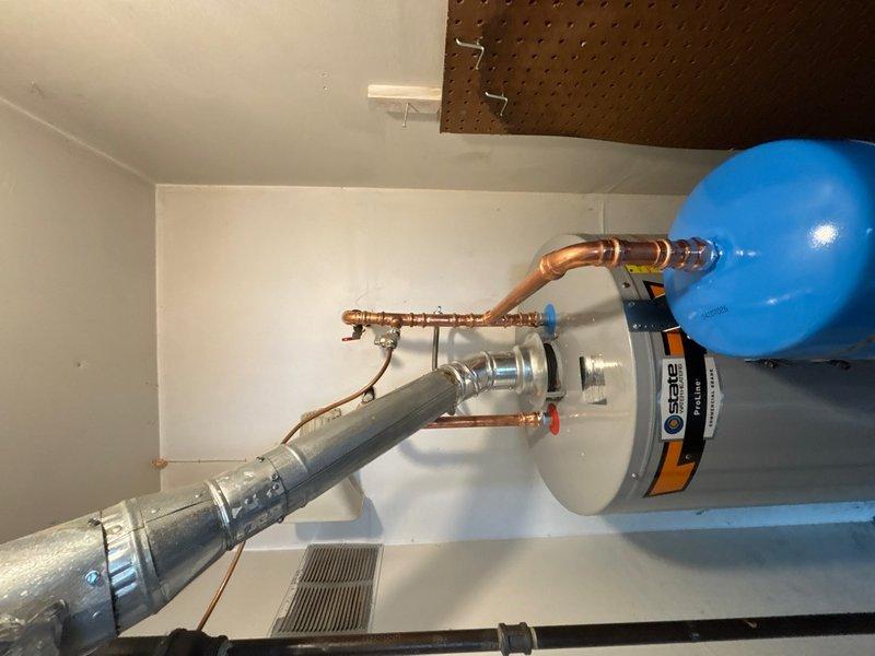 Successfully installed a 50-gallon gas water heater in the utility closet, including all necessary plumbing connections with copper piping, brass fittings, and shut-off valves. Mounted and connected a blue expansion tank to the system and installed proper ventilation ductwork to ensure safe exhaust of combustion gases. All components were installed to code with appropriate safety labels visible, system tested for proper operation, and workspace left clean upon completion.