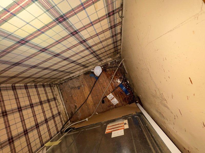 Responded to reported leak in wall concern. Conducted thorough inspection of accessible plumbing areas, including crawlspace beneath affected room and interior wall cavity. Located blue PVC drainage piping with compression fittings secured to floor joists, showing signs of moisture exposure on surrounding wooden structural members with visible staining and discoloration. Identified significant water damage and deterioration at interior wall corner with dark staining indicative of active or previous moisture intrusion. Documented conditions with photographs for reference and further assessment recommendations.