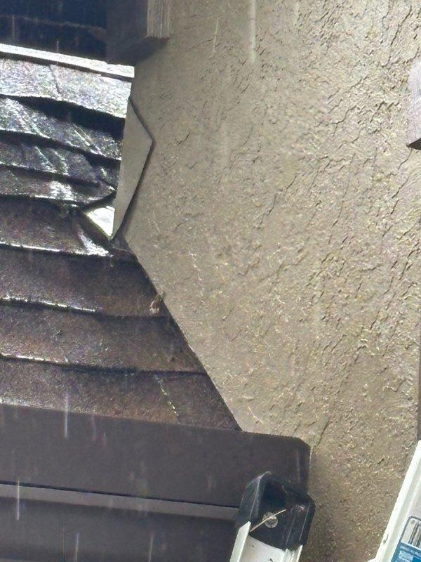 Responded to report of water dripping in basement originating from master bathroom area. Conducted thorough leak location inspection of affected areas including basement ceiling, HVAC system components, and exterior drainage systems. Investigated potential sources including plumbing fixtures, supply lines, and building envelope penetrations. Documented findings with photographic evidence showing HVAC ductwork, spray foam insulation at wall junctions, and exterior downspout drainage system with landscape rock bed at building foundation. Identified areas requiring further monitoring or repair to resolve moisture intrusion issue.