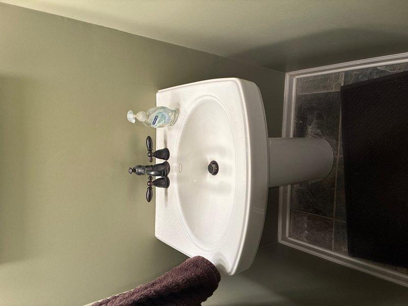 Completed plumbing maintenance visit addressing kitchen and bathroom fixtures. Inspected kitchen faucet assembly and sink connections for proper operation and leaks, and evaluated bathroom pedestal sink with cross-handle faucet controls for functionality and drainage performance. All fixtures found to be operating within normal parameters with no immediate repairs required.
