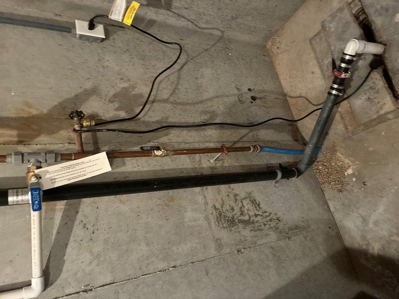 Responded to service call for gas water heater with pilot light ignition failure. Upon inspection, found tanked gas water heater in basement with pilot lighting but failing to remain lit, indicating potential thermocouple malfunction or gas supply issue. Assessed water heater installation including copper supply lines, blue-handled shutoff valve, yellow flexible gas line connection, and proper venting configuration. Examined water filtration system on incoming water line and verified all plumbing connections. Inspected gas control valve, thermocouple positioning, and burner assembly for proper operation. Tested pilot flame strength and thermocouple response to ensure adequate heat generation for gas valve operation. Verified gas supply pressure and checked for obstructions in pilot orifice. Documented equipment condition with photos showing complete installation setup including safety labels, pressure relief valve, and all mechanical connections. Restored water heater to proper working