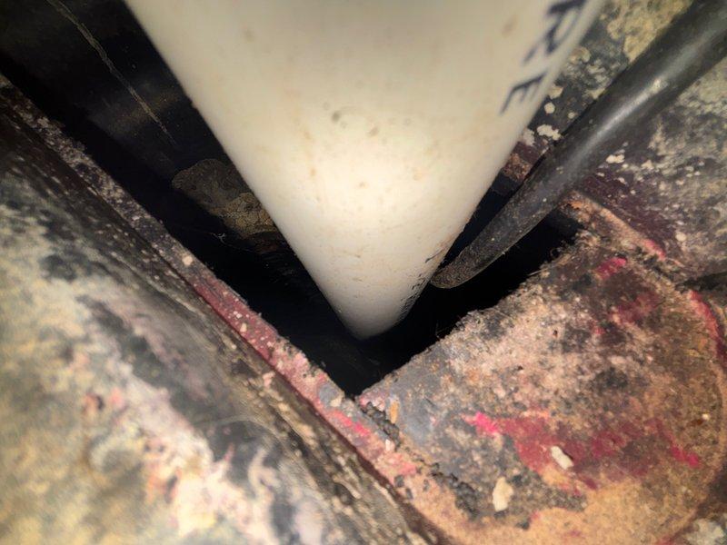 # Plumbing Maintenance Visit

Completed scheduled plumbing maintenance inspection of water meter assembly and associated piping system. Documented existing conditions including aged copper supply lines with oxidation, brass shut-off valves with red handles in operational position, and water meter with visible face readings. Observed significant ceiling moisture staining above plumbing installation indicating past water intrusion. Photographed corroded metal pipes and fittings showing advanced deterioration from long-term moisture exposure, along with bundled electrical cables secured beneath meter assembly. All components accessible and system currently functional at time of inspection.