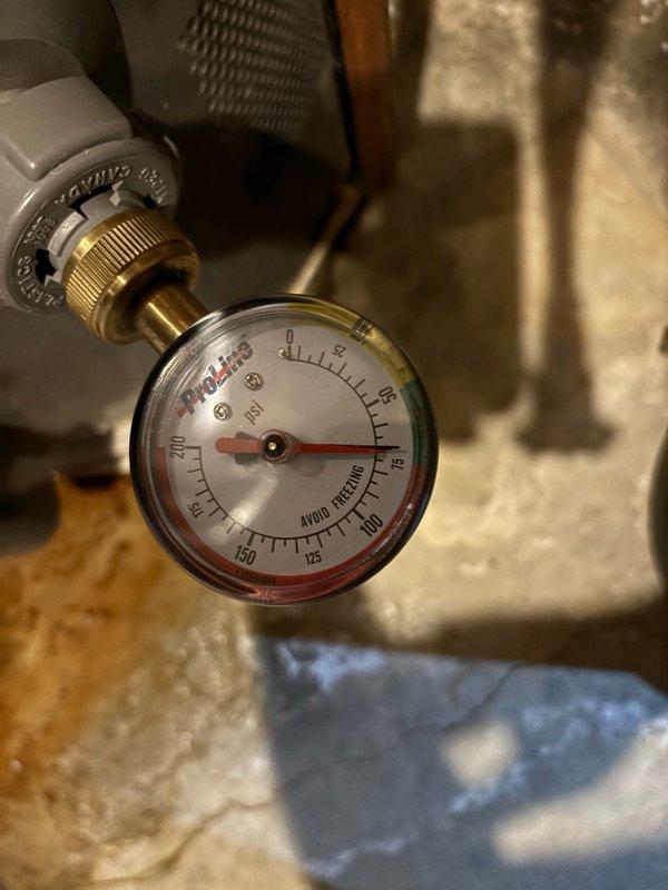 Responded to reported leak on gas-fired tanked water heater in basement. Upon inspection, identified active leak requiring immediate attention. Performed diagnostic assessment of unit and associated plumbing connections, including evaluation of pressure relief valve, supply lines, and tank integrity. Documented existing system configuration showing Performance-brand water heater with copper supply piping, blue-handled isolation valve, and PVC venting. Verified system pressure readings using calibrated gauge. Completed necessary repairs to resolve leak condition and restore proper operation. Tested all connections for integrity post-repair and confirmed system returned to normal operating parameters with no further water discharge observed.