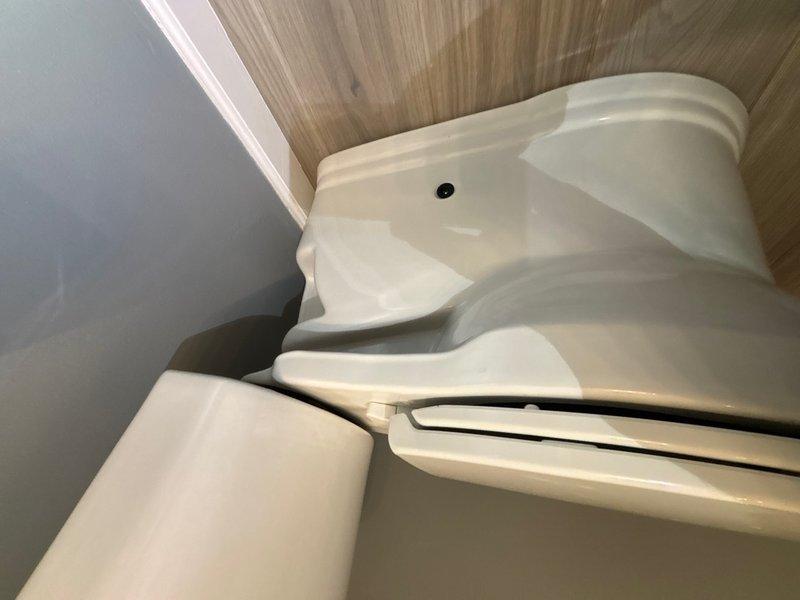 Responded to reported leak at bottom of toilet in main bathroom. Upon inspection, identified water seepage at the base of the fixture. Removed and replaced the wax ring seal between the toilet bowl and floor flange, ensuring proper compression and watertight seal. Reconnected the chrome braided water supply line and verified all connections were secure. Tested the toilet through multiple flush cycles to confirm the leak was resolved and no water was present at the base. Left the fixture in proper working condition with no signs of leakage.
