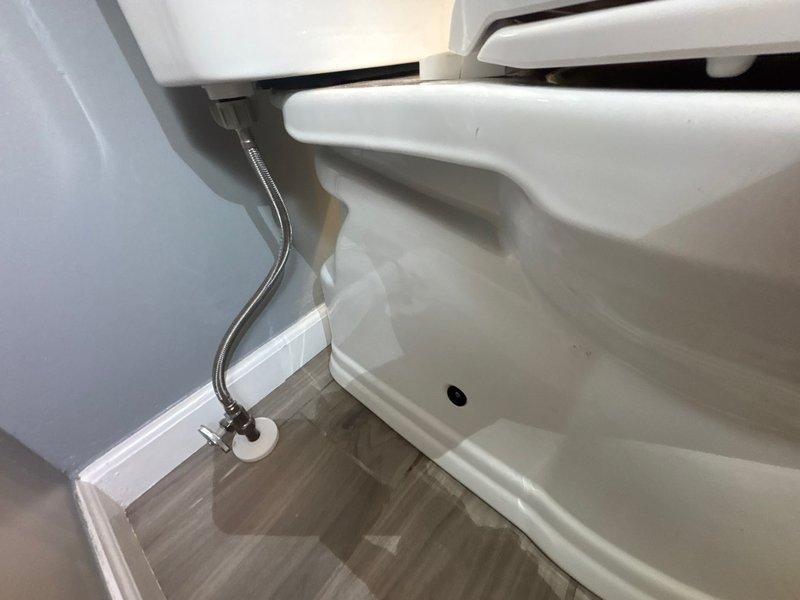 Responded to reported leak at bottom of toilet in main bathroom. Upon inspection, identified water seepage at the base of the fixture. Removed and replaced the wax ring seal between the toilet bowl and floor flange, ensuring proper compression and watertight seal. Reconnected the chrome braided water supply line and verified all connections were secure. Tested the toilet through multiple flush cycles to confirm the leak was resolved and no water was present at the base. Left the fixture in proper working condition with no signs of leakage.