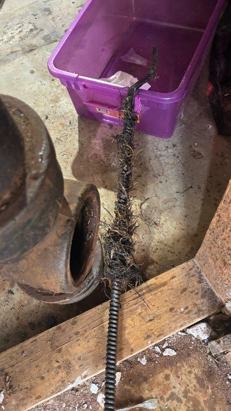 Responded to main line backup issue and performed diagnostic assessment of the drainage system. Utilized mechanical auger equipment to clear the main sewer line obstruction, successfully removing significant accumulation of debris and buildup that was causing the backup condition. Documented pre-service and post-service conditions with photographic evidence showing the extent of material extracted from the line.