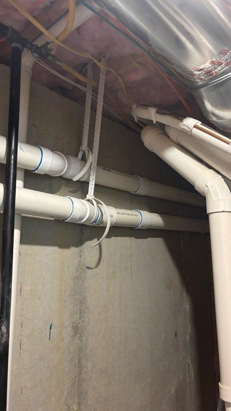 Responded to Error 29 code on tankless water heater system. Inspected unit and verified proper venting configuration with 3-inch PVC exhaust and intake pipes installed with appropriate 90-degree elbows extending through floor joists. Cleared error code by addressing combustion air flow issue and confirmed all venting connections were secure and properly sealed. System tested and returned to normal operation with no further error codes displayed.
