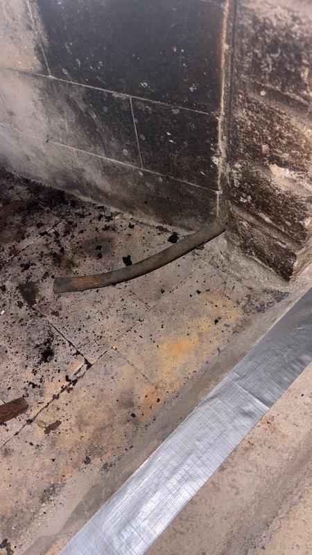 Responded to service call for gas line capping in chimney chase located in downstairs living area. Upon arrival, assessed the gas line configuration in deteriorated interior space showing significant moisture damage and staining. Successfully capped off the gas line per code requirements to ensure safe disconnection of gas supply. Inspected associated piping infrastructure in attic space above, confirming proper connection points and verifying no additional gas lines required attention in the vicinity of HVAC equipment and structural framing.